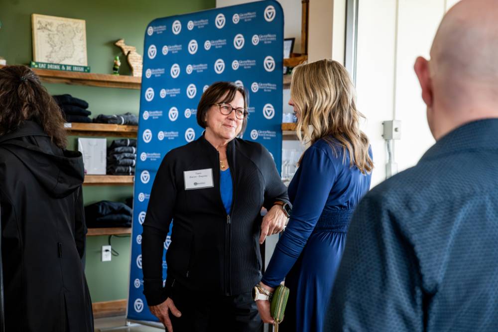 Two alums talking at Rove.